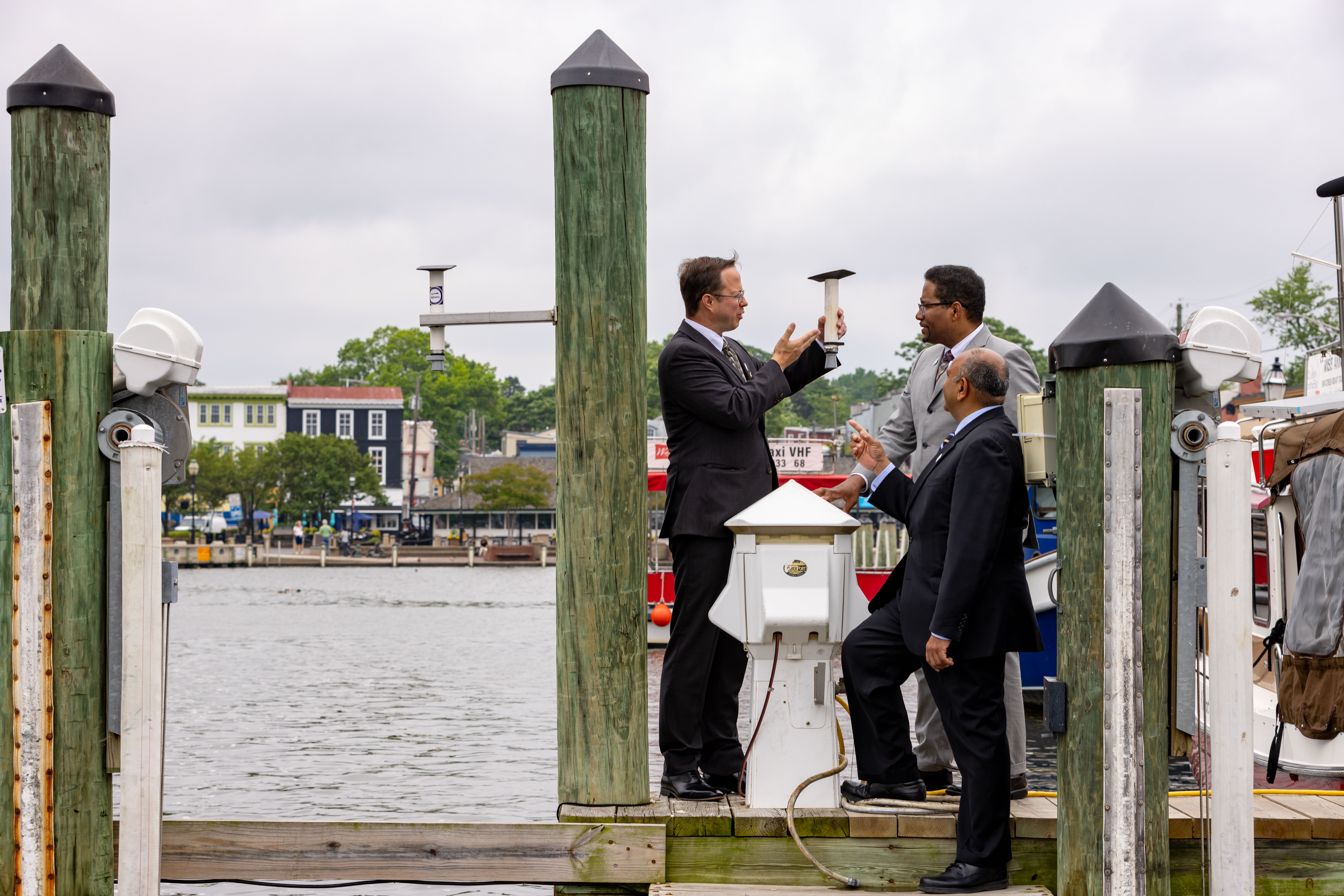 Tim Canty shows HydroNet sensor to President Darryll Pines and Dean Amitabh Varshney