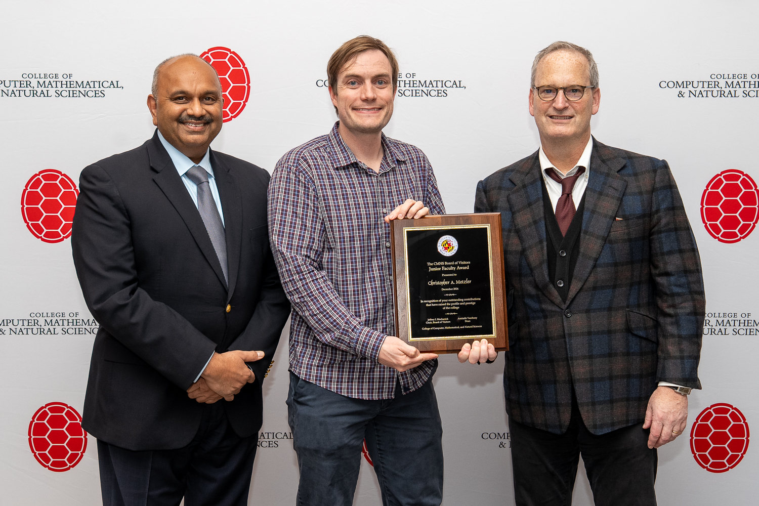Amitabh Varshney, Christopher Metzler and Jeffrey Mechanick in front of CMNS branded backdrop