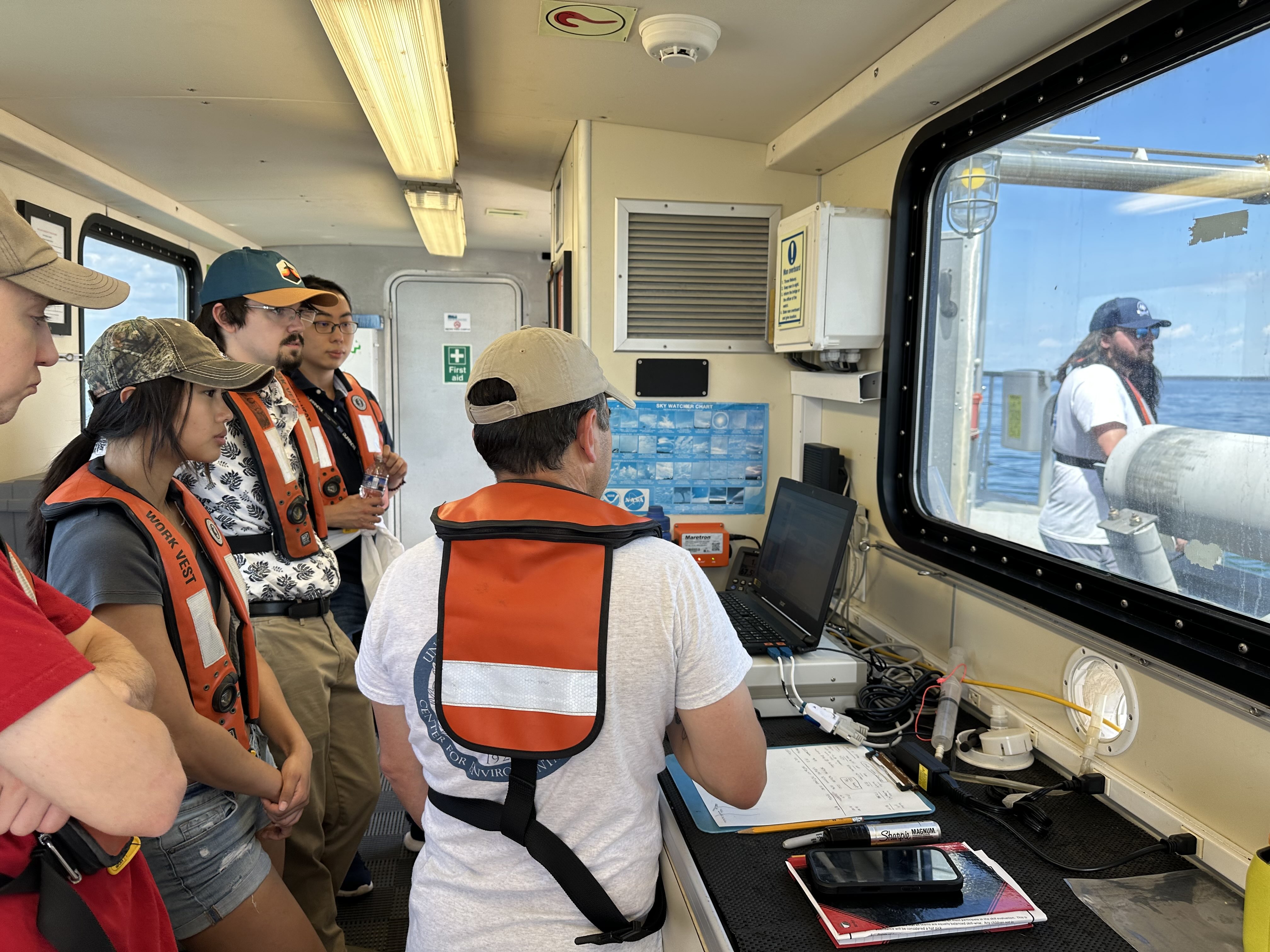 Students inside the ship looking at a computer