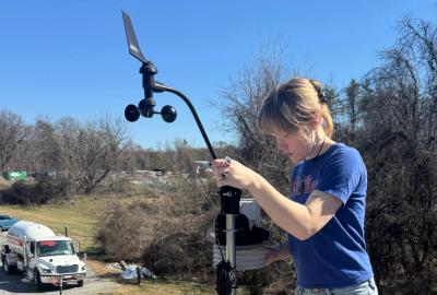 Four students assemble a Mesoterps' weather station.