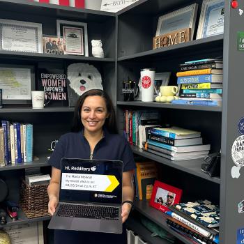 Maria Molina holding an open laptop