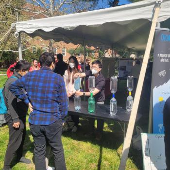 students demonstrating tornados in a bottle at Maryland Day