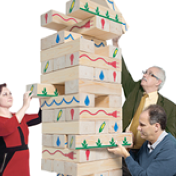 middle aged people playing giant Jenga
