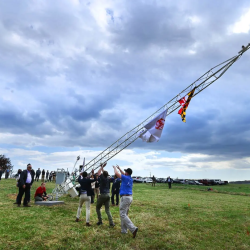 weather tower being raised in a field