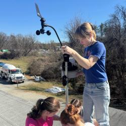 Four students assemble a Mesoterps' weather station.
