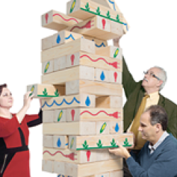 middle aged people playing giant Jenga
